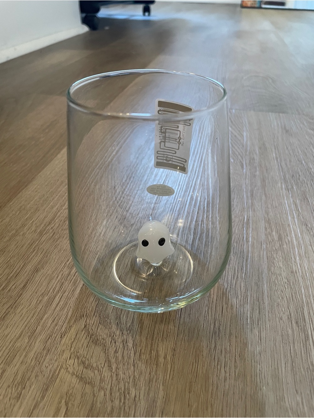 Stemless ghost wine glass with Halloween ghost figurine at bottom
